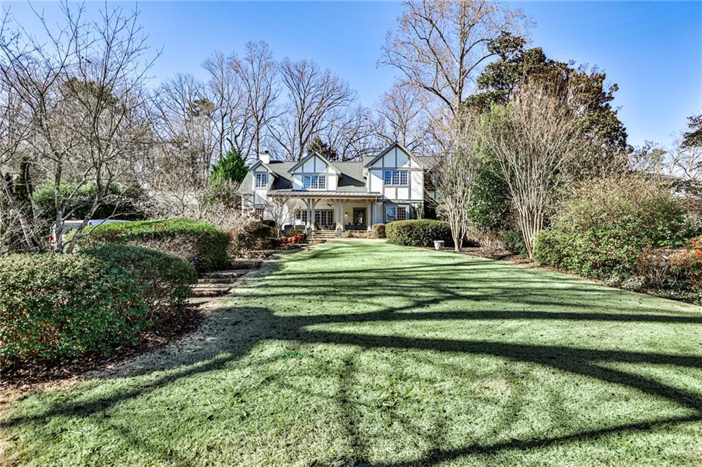 998 Springdale Road Northeast Atlanta, GA 30306 - Photo 1 of 1 a front view of a house with a yard table and chairs