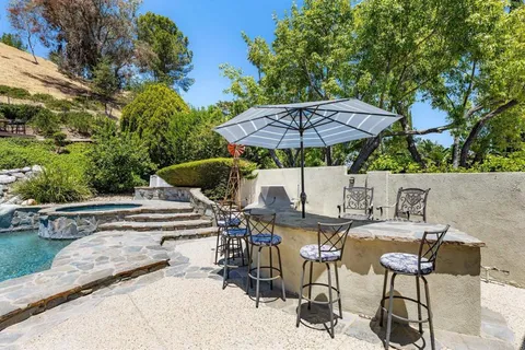 an aerial view of a house with yard swimming pool and outdoor seating