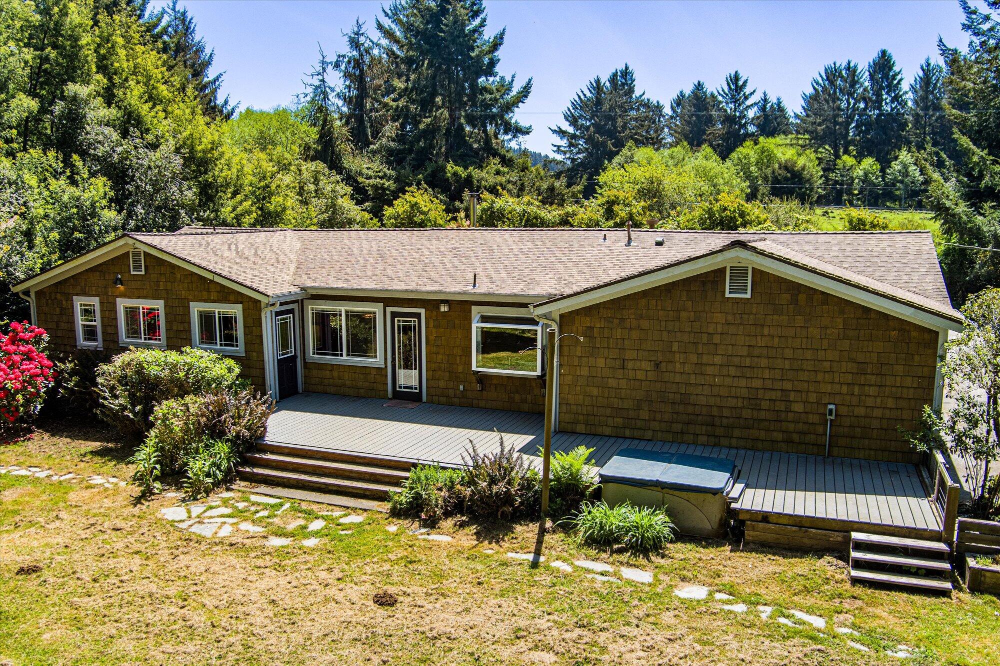 1945 Grange Road McKinleyville, CA 95519 - Photo 61 of 62 a front view of a house with a yard and a garden