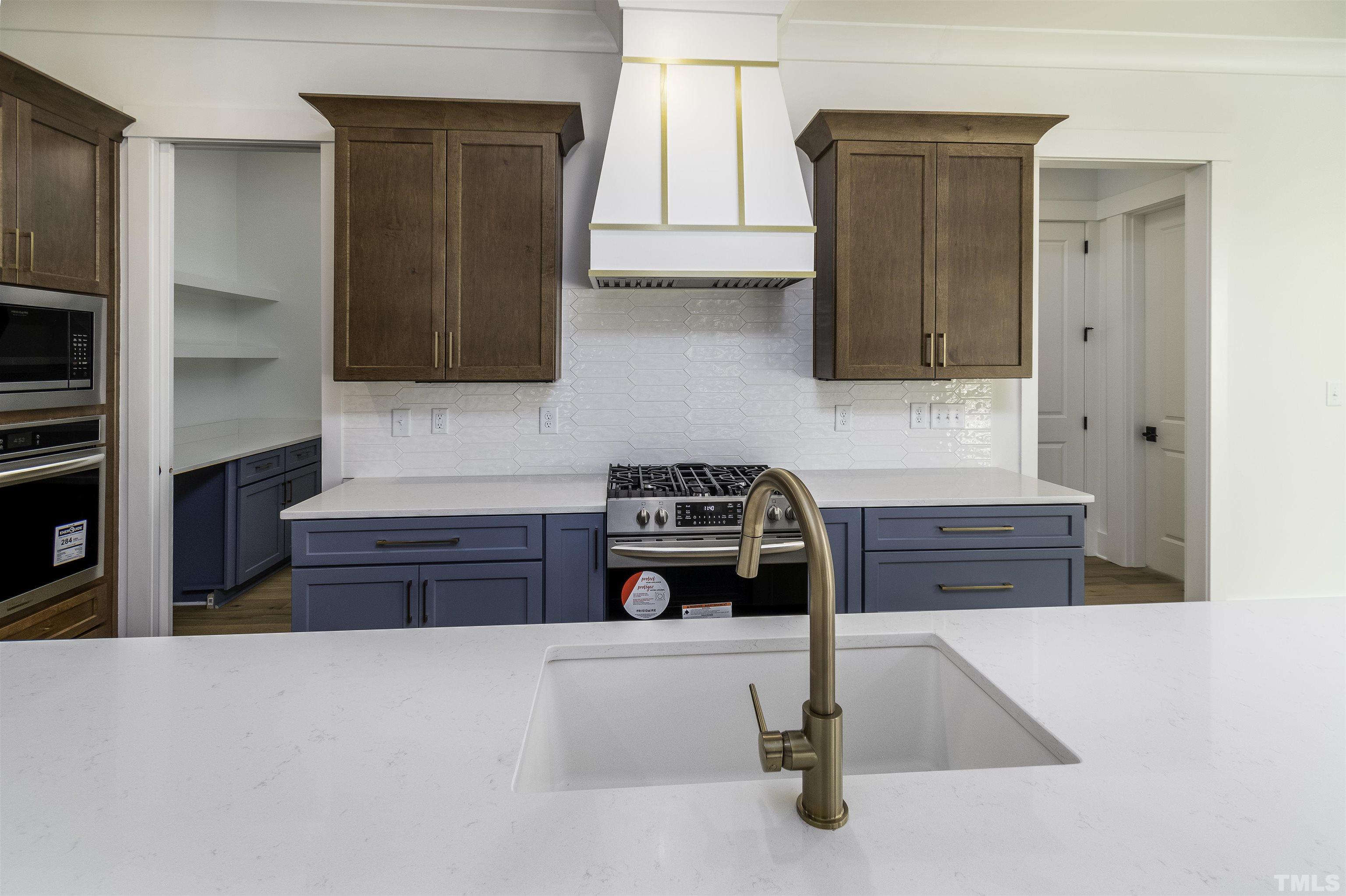 3725 Doyle Road Zebulon, NC 27597 - Photo 8 of 51 a kitchen with wooden cabinets and a stove top oven