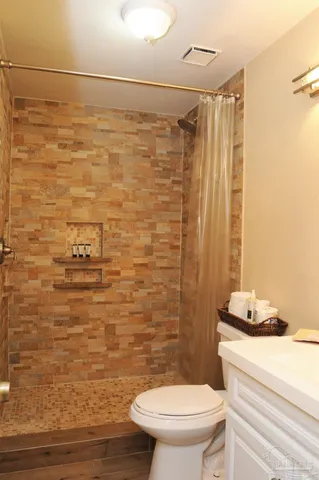 a bathroom with a toilet and a shower