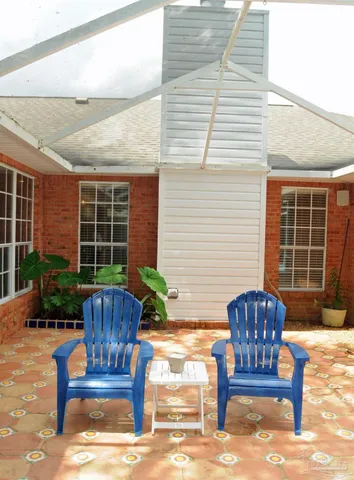a view of a chairs and table in back yard of the house