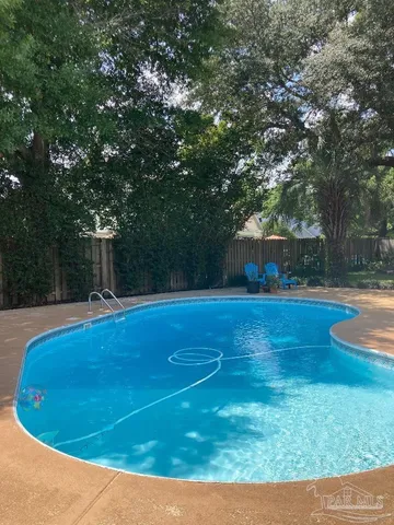 a view of a swimming pool with a yard