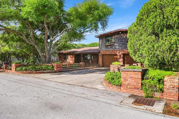 a backyard of a house with barbeque oven table and chairs