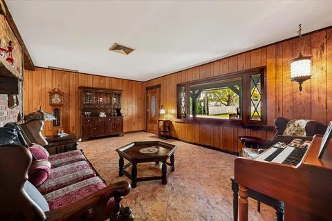 a living room with furniture a window and a clock