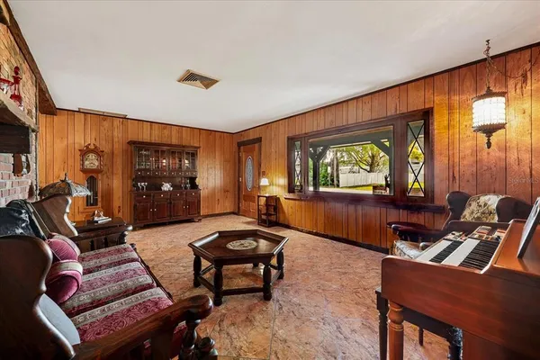 a living room with furniture a window and a clock