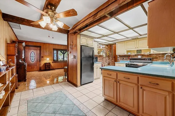 a kitchen with stainless steel appliances granite countertop a refrigerator and a sink