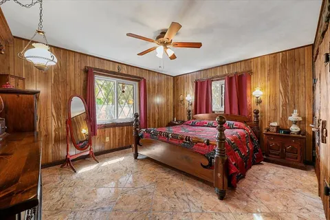 a bedroom with furniture and a window