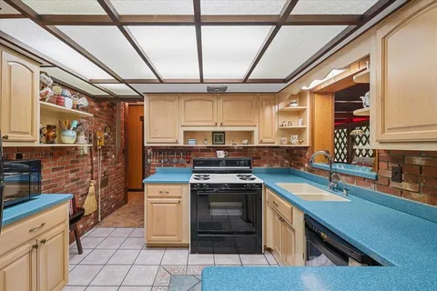 a kitchen with a stove sink and cabinets
