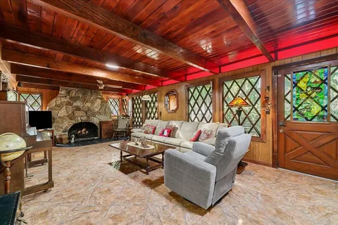 a living room with furniture a fireplace and a table