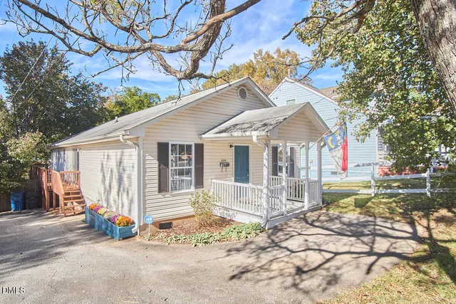 a view of a house with a small yard and wooden fence