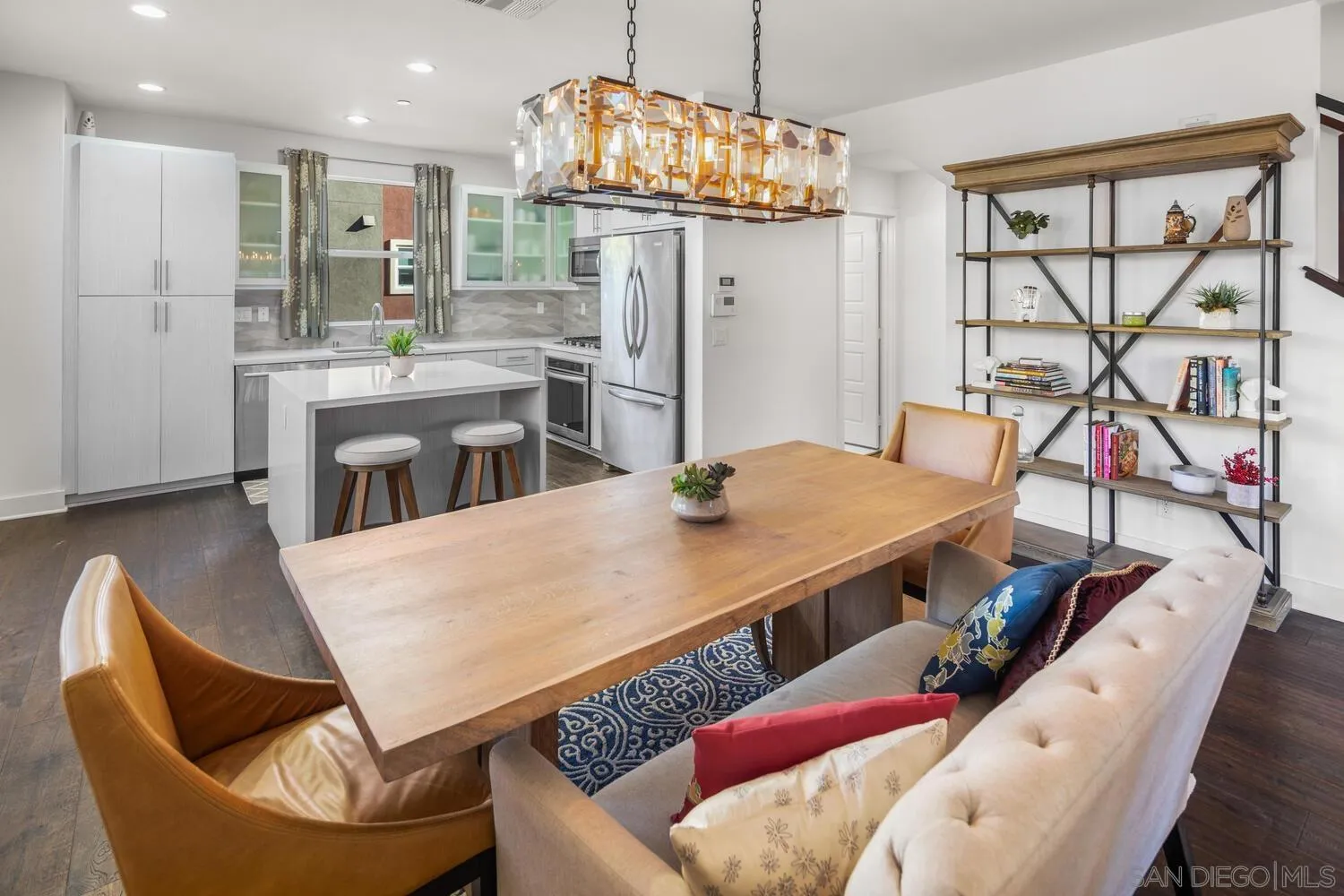 a living room with stainless steel appliances kitchen island granite countertop furniture and a kitchen view