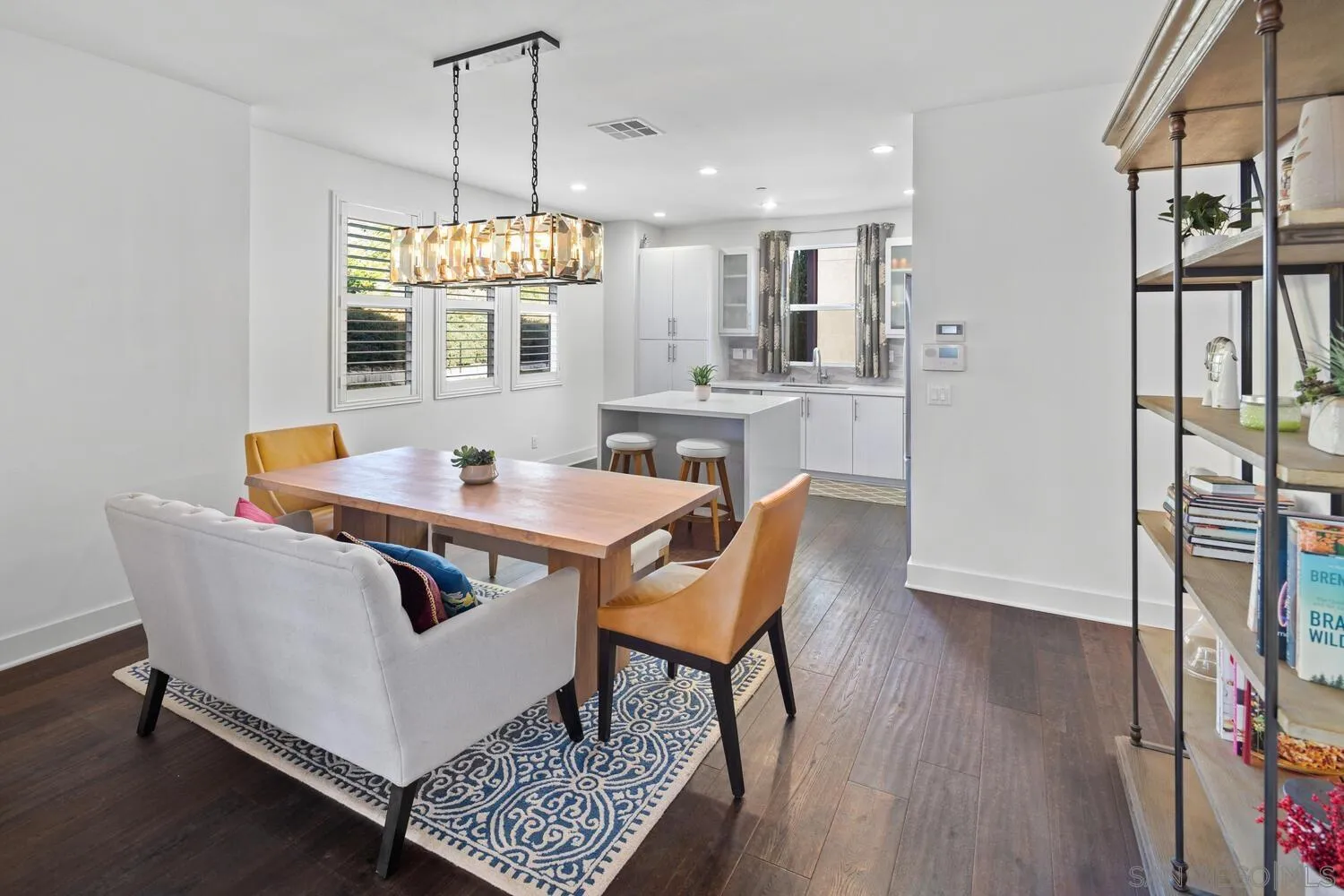 7845 Modern Oasis Drive San Diego, CA 92108 - Photo 13 of 39 a view of a dining room with furniture window and wooden floor
