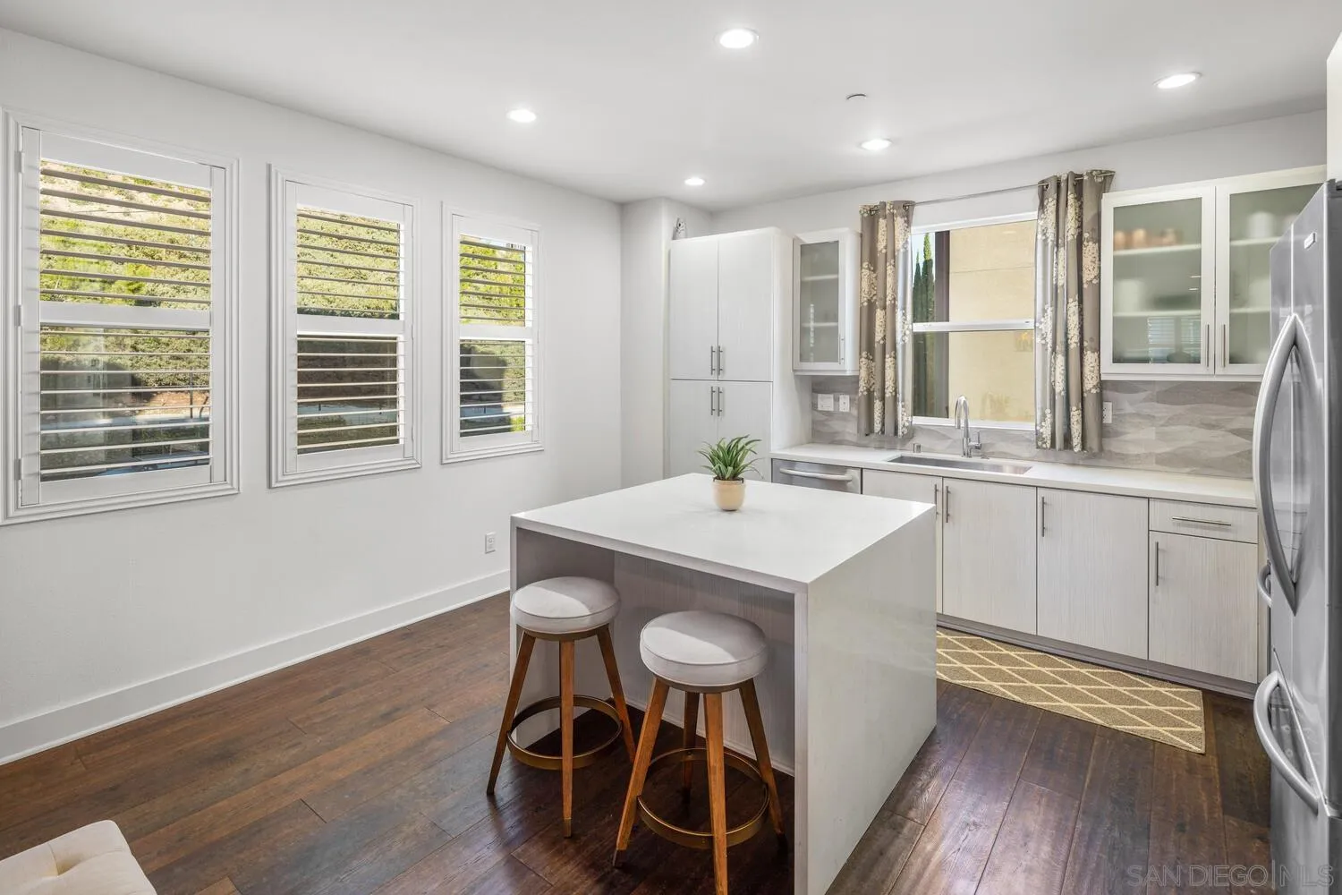 7845 Modern Oasis Drive San Diego, CA 92108 - Photo 15 of 39 a kitchen with a sink appliances cabinets and a large window