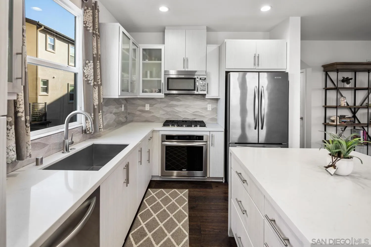 7845 Modern Oasis Drive San Diego, CA 92108 - Photo 16 of 39 a kitchen with a sink stove and refrigerator