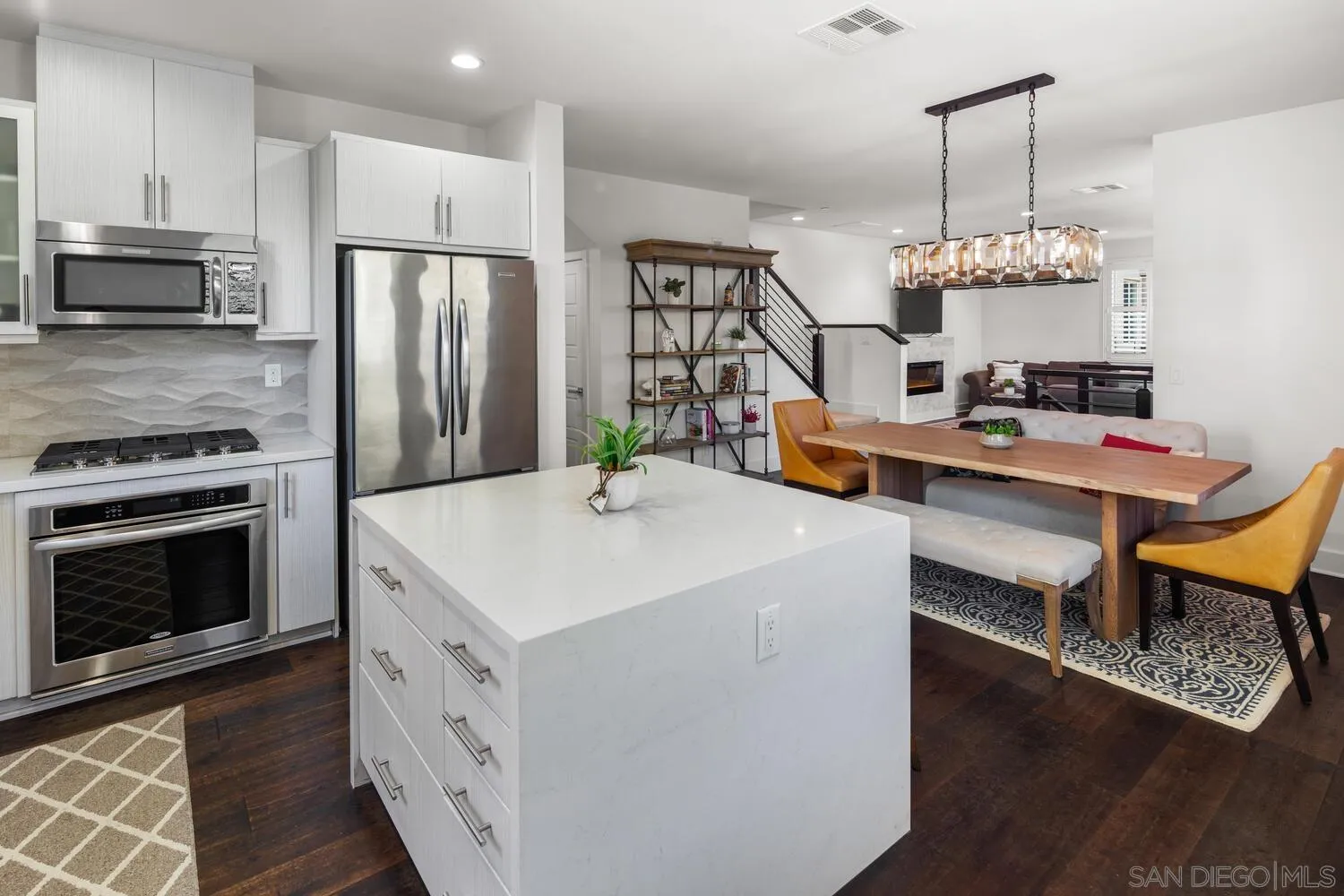 7845 Modern Oasis Drive San Diego, CA 92108 - Photo 17 of 39 a kitchen with a refrigerator a stove and a wooden floor