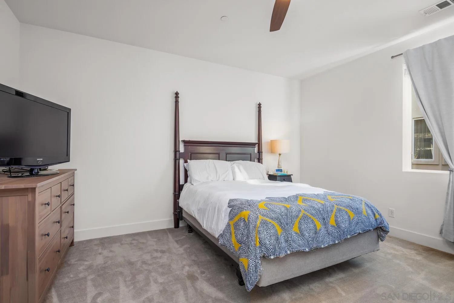 7845 Modern Oasis Drive San Diego, CA 92108 - Photo 21 of 39 a bedroom with a bed and flat screen tv