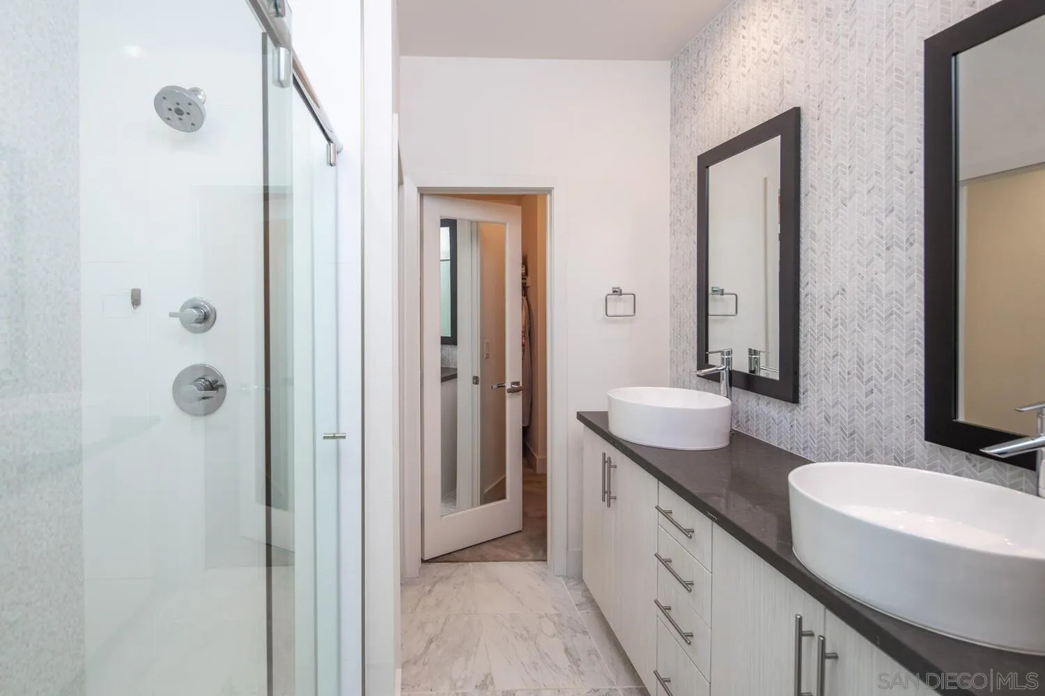 7845 Modern Oasis Drive San Diego, CA 92108 - Photo 24 of 39 a spacious bathroom with a double vanity sink and a mirror