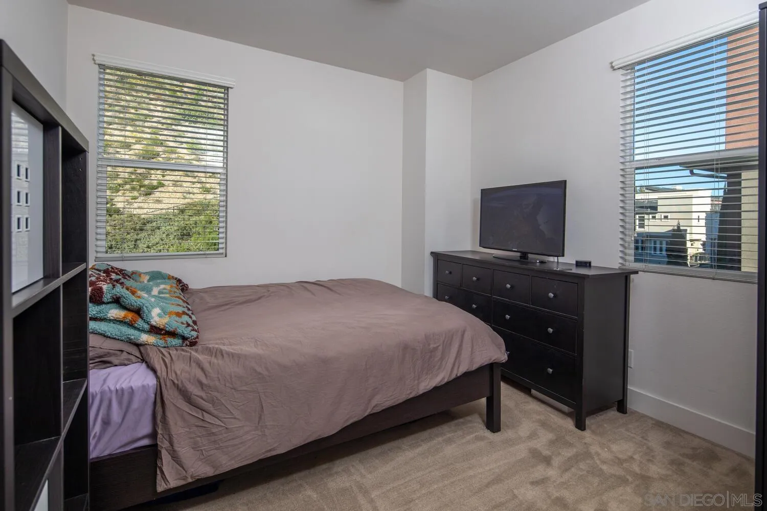 7845 Modern Oasis Drive San Diego, CA 92108 - Photo 26 of 39 a bedroom with a bed and flat tv screen on the dresser