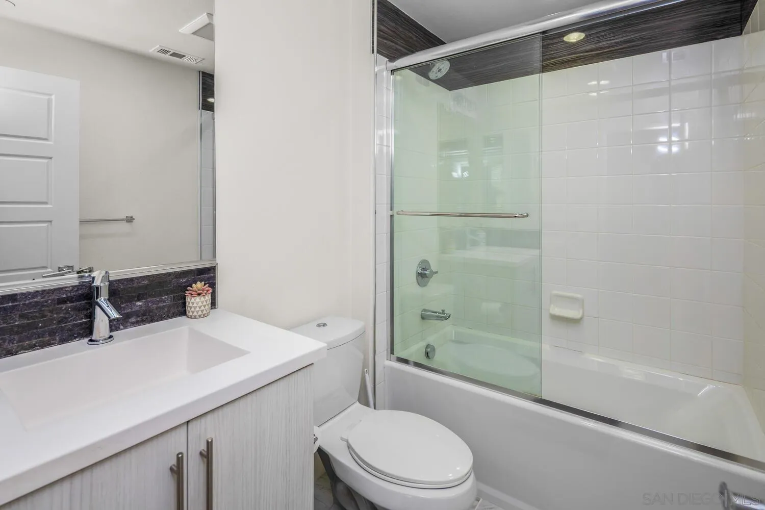 7845 Modern Oasis Drive San Diego, CA 92108 - Photo 27 of 39 a bathroom with a sink toilet and shower