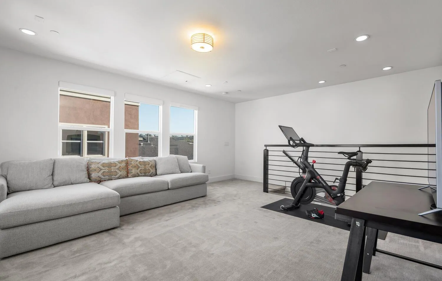 7845 Modern Oasis Drive San Diego, CA 92108 - Photo 30 of 39 a living room with furniture a window and gym equipment