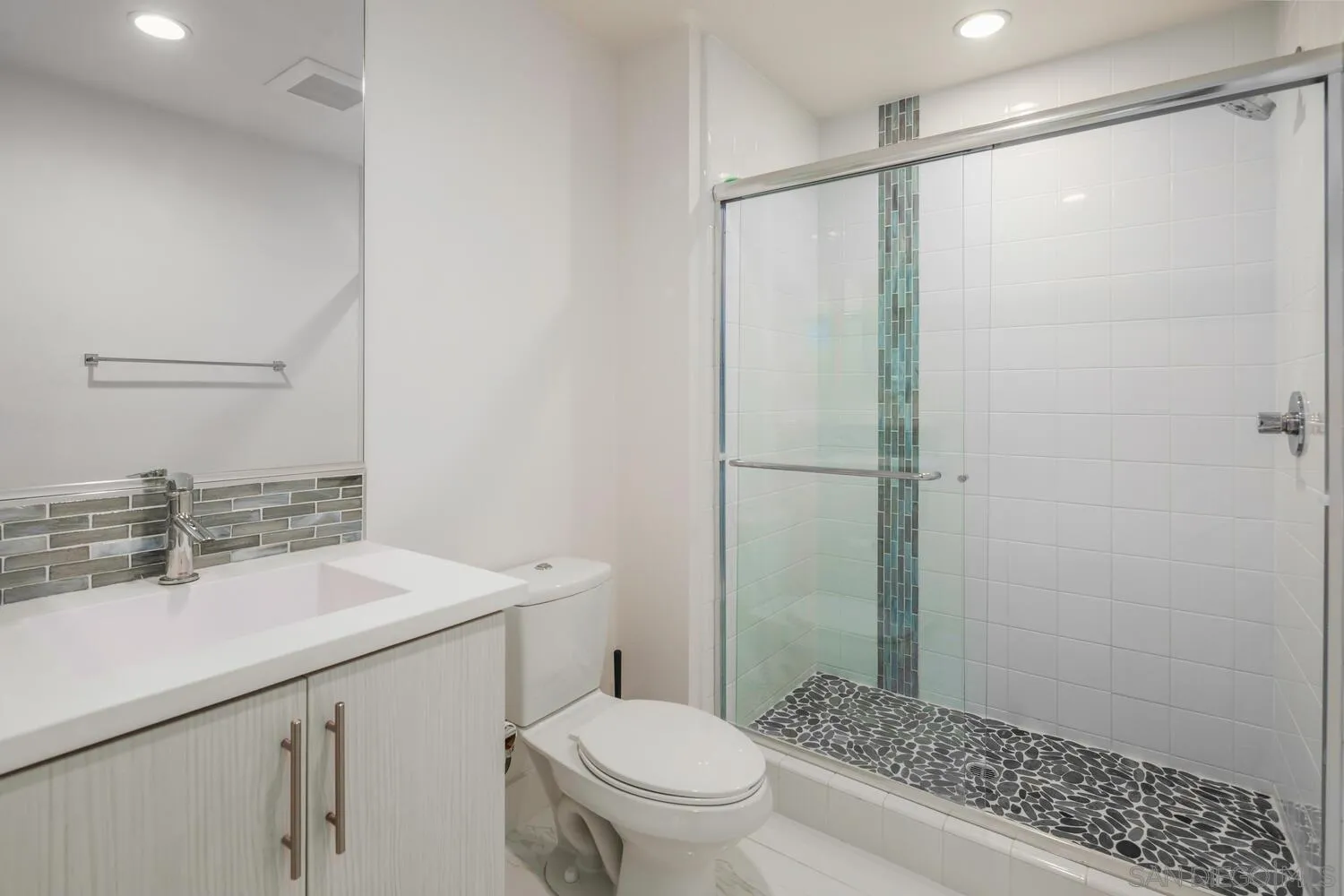 7845 Modern Oasis Drive San Diego, CA 92108 - Photo 9 of 39 a bathroom with a sink a toilet and shower