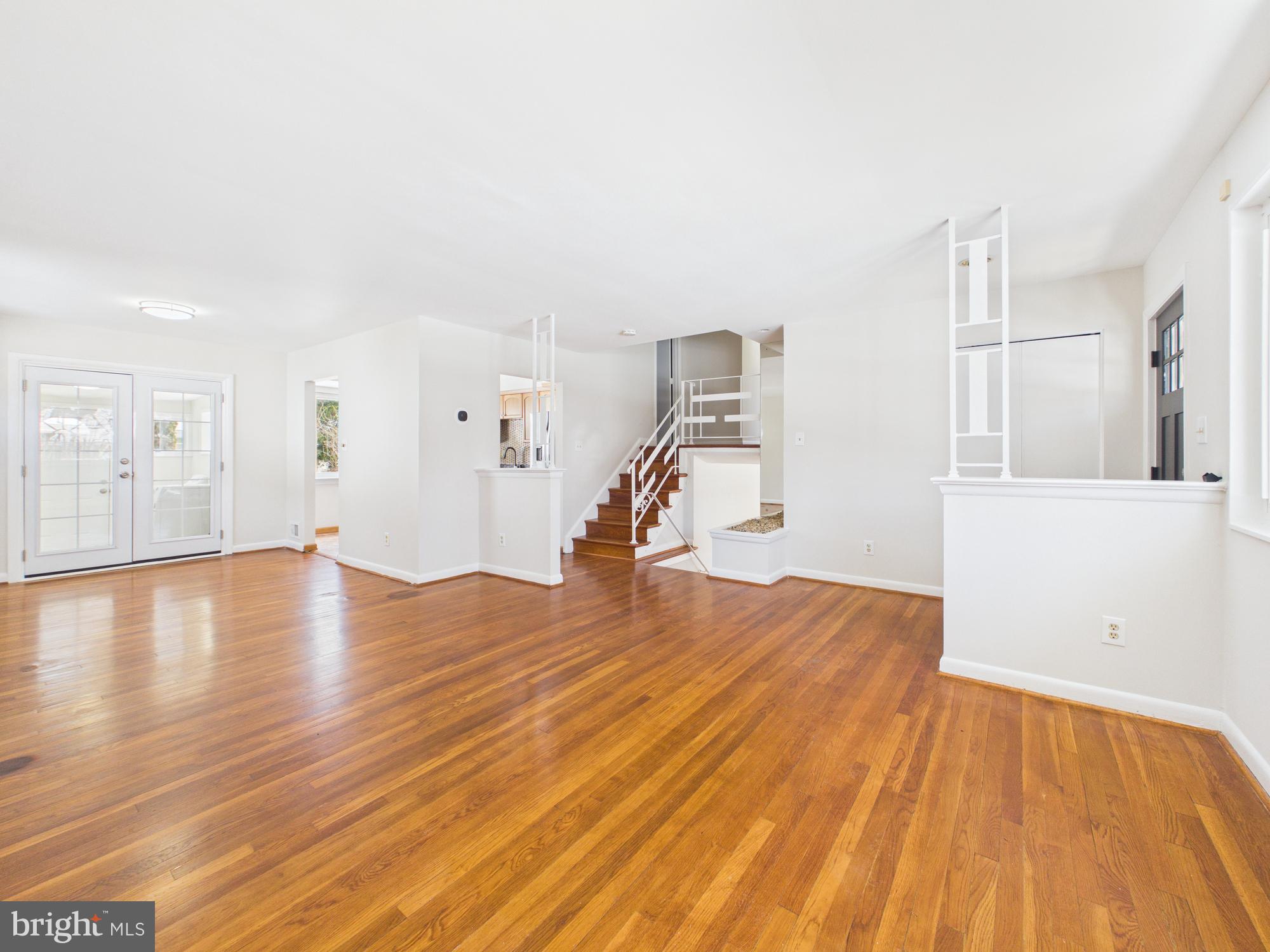 a view of empty room with wooden floor and chair