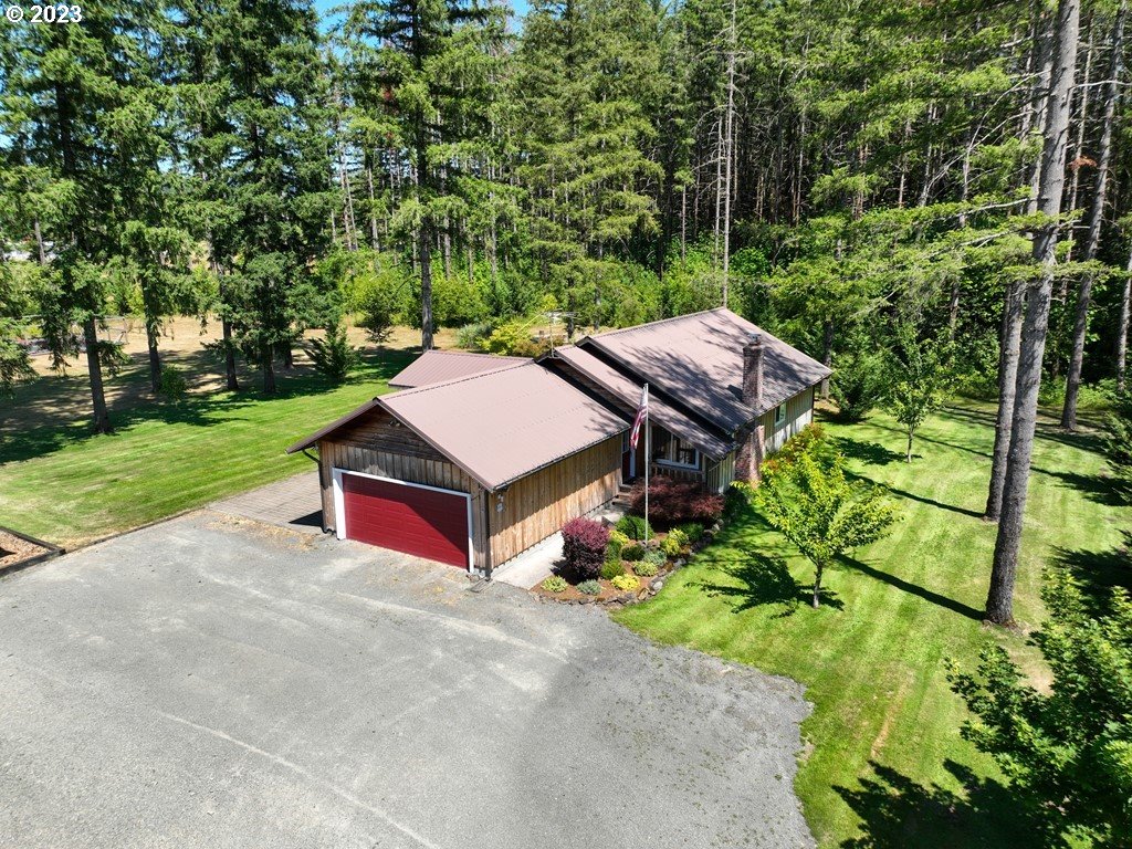 30400 Northeast Healy Road Amboy, WA 98601 - Photo 1 of 48 a aerial view of a house with swimming pool and garden