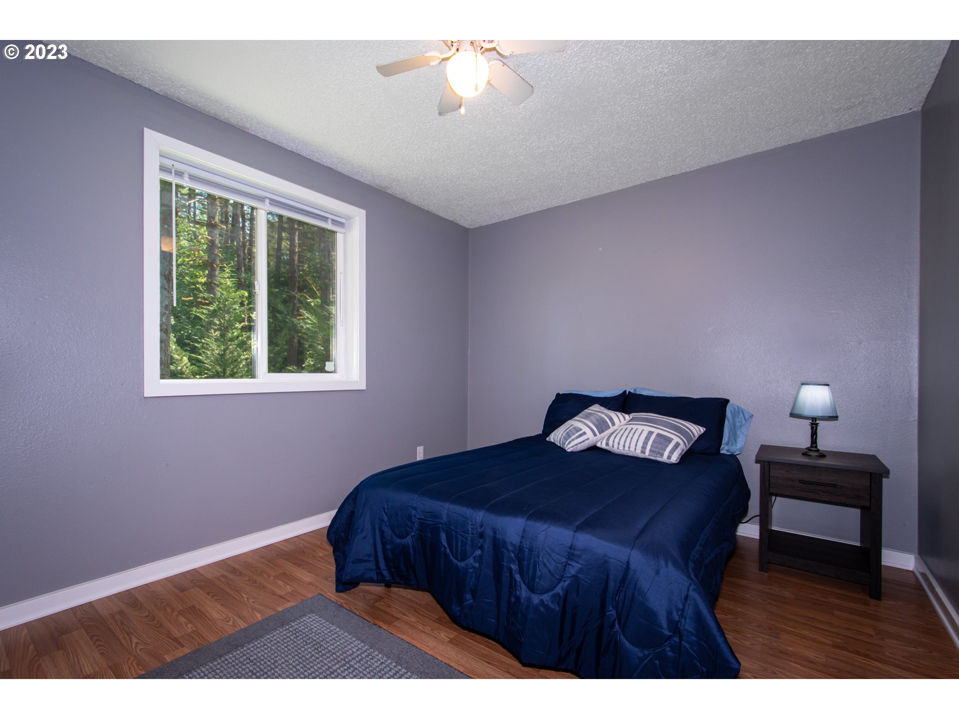 30400 Northeast Healy Road Amboy, WA 98601 - Photo 17 of 48 a bedroom with a bed and a lamp on table