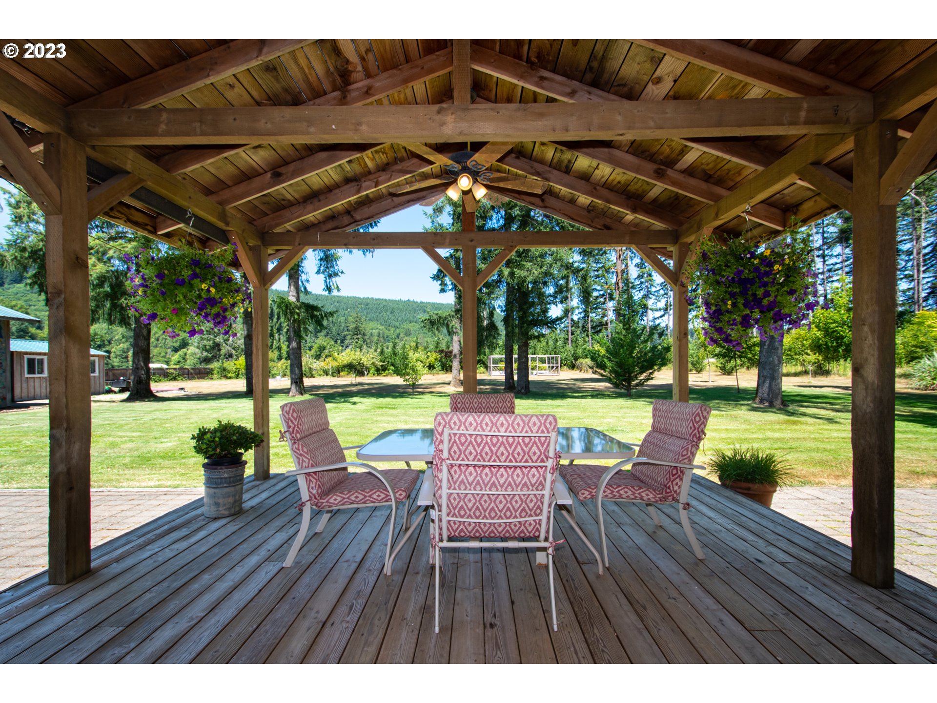 30400 Northeast Healy Road Amboy, WA 98601 - Photo 21 of 48 a view of a wooden chairs and table in patio with a small yard