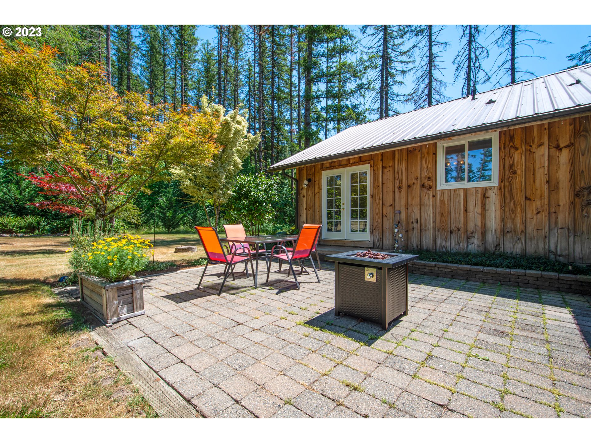 30400 Northeast Healy Road Amboy, WA 98601 - Photo 23 of 48 a view of a patio with table and chairs and potted plants