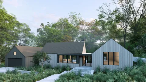 a front view of a house with a yard and trees