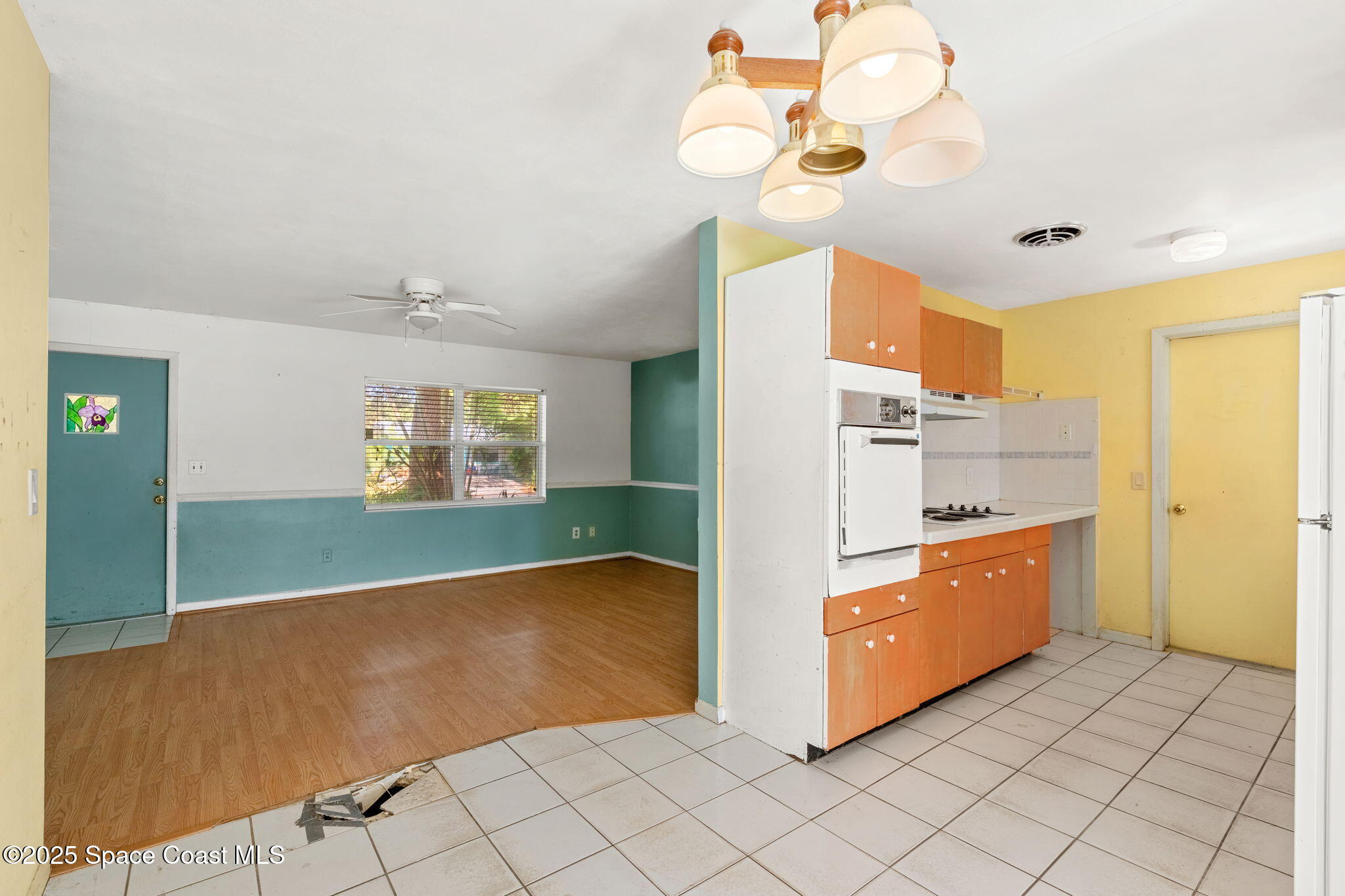 271 Fay Drive Indialantic, FL 32903 - Photo 8 of 27 a kitchen with stainless steel appliances granite countertop a sink a stove top oven and cabinets