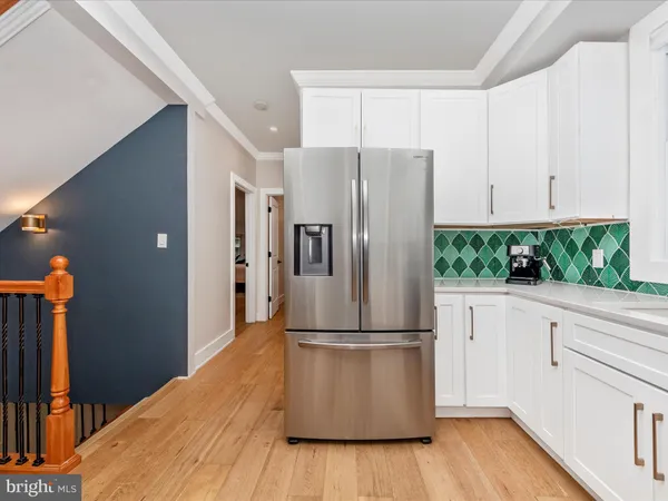 a kitchen with stainless steel appliances a refrigerator sink and cabinets