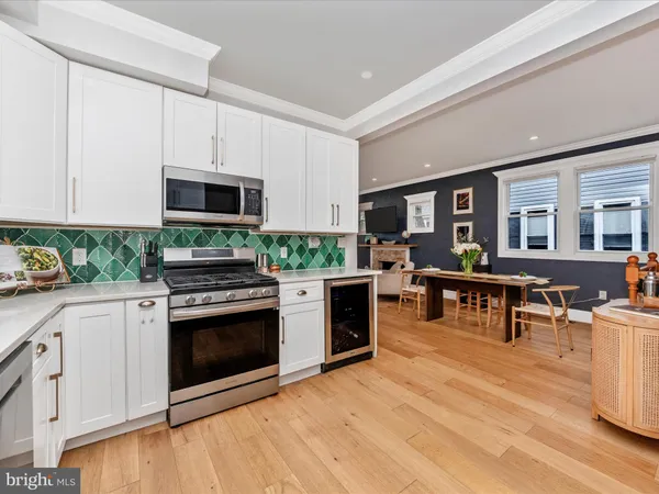 a kitchen with stainless steel appliances granite countertop a stove and cabinets