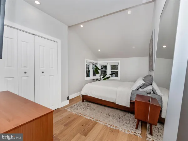 a bedroom with a bed and a chair