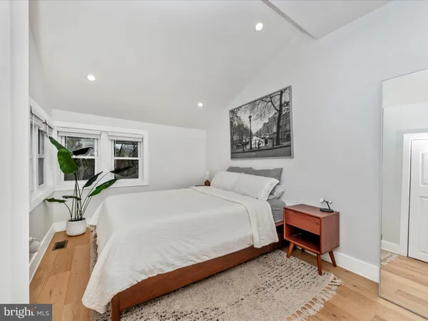 a bed room with a bed and a chair