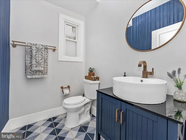 a bathroom with a sink a toilet and a mirror