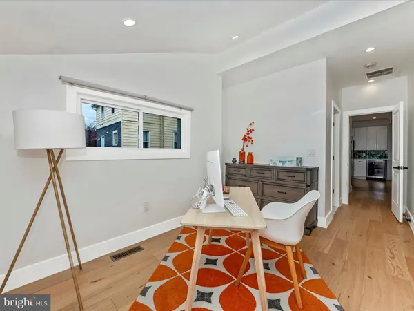 a living room with a rug and a dining table