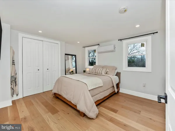 a bedroom with a large bed and a painting on the wall