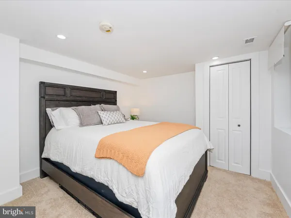 a bedroom with a bed and a night stand