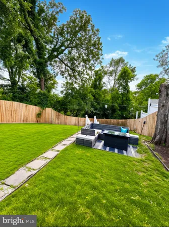 a view of a chair and table in the garden
