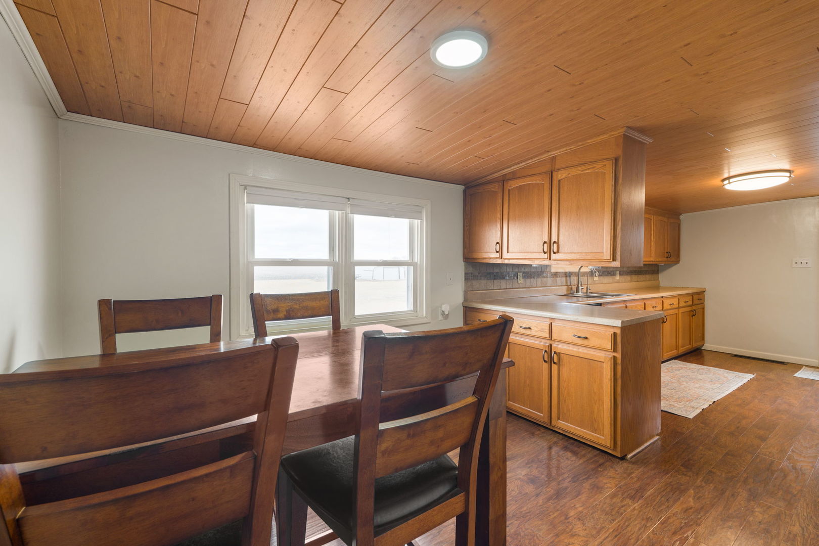 12596 East 200th Street Orion, IL 61273 - Photo 3 of 27 a view of kitchen with granite countertop cabinets table and chairs