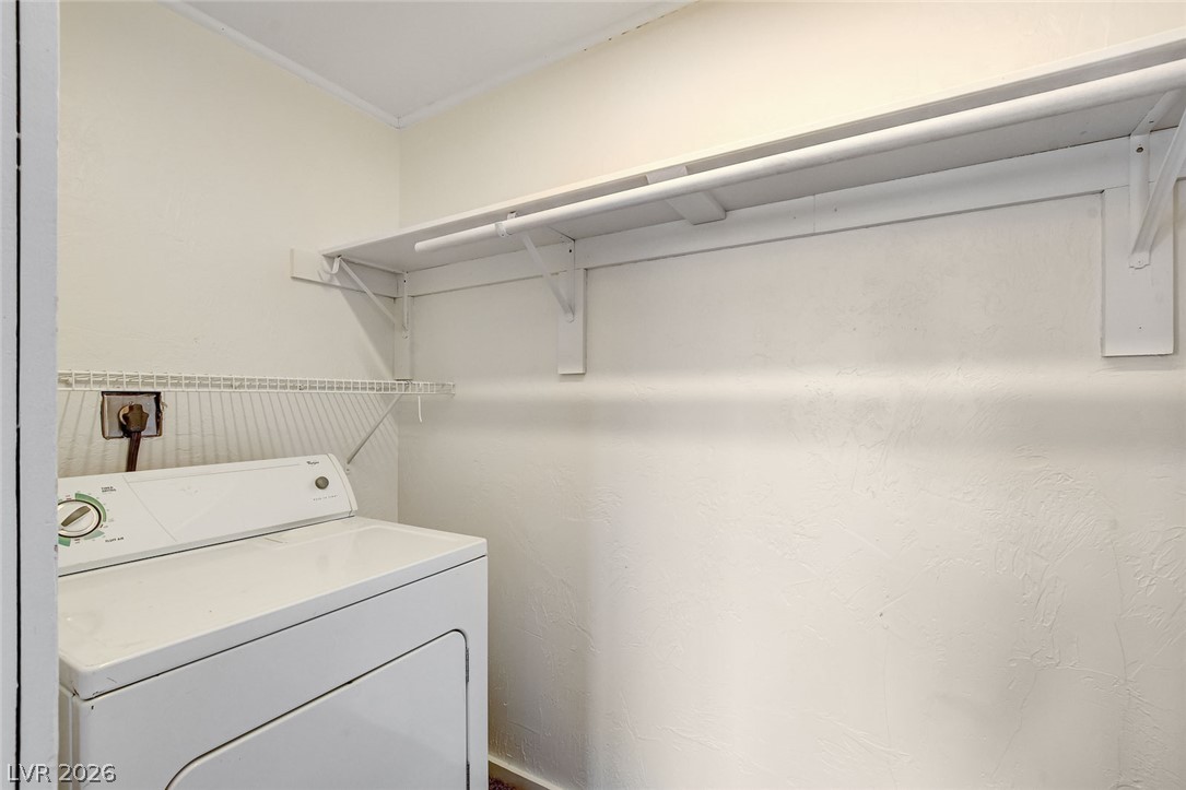 214 West Victory Road Henderson, NV 89015 - Photo 26 of 33 Functional laundry space featuring convenient overhead shelving and a robust clothes rod.