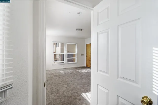 a view of an empty room with windows