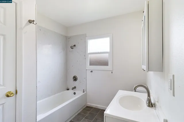 a bathroom with a sink a bathtub and shower
