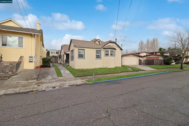 a house that has a tree in front of it