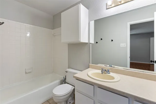 a bathroom with a sink toilet vanity and tub
