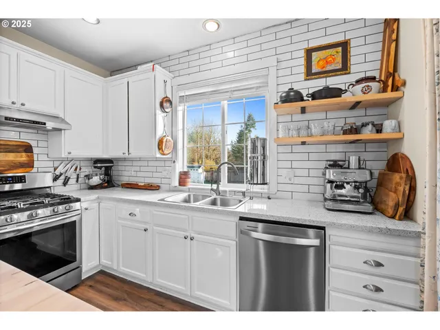 a kitchen with stainless steel appliances granite countertop a stove and a sink