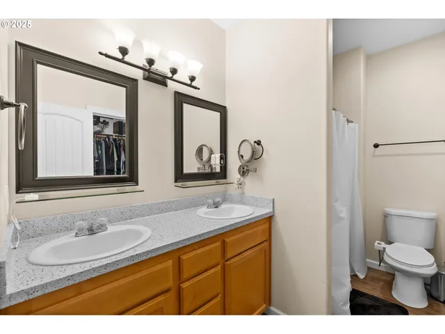 a bathroom with a granite countertop sink a toilet and a mirror